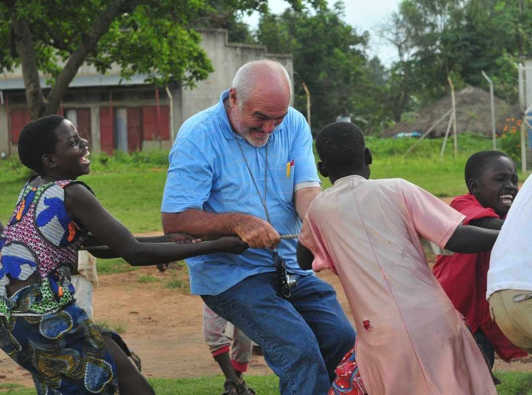 Brother Elio Croce sharing a light moment with children in Northern Uganda.